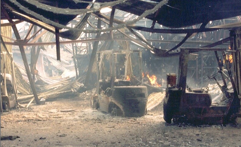 Fire damaged building with collapsed roof.