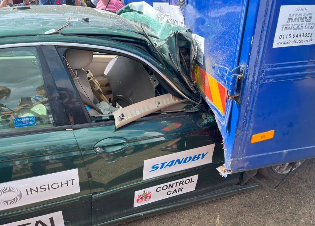 saloon car under HGV at 60mph